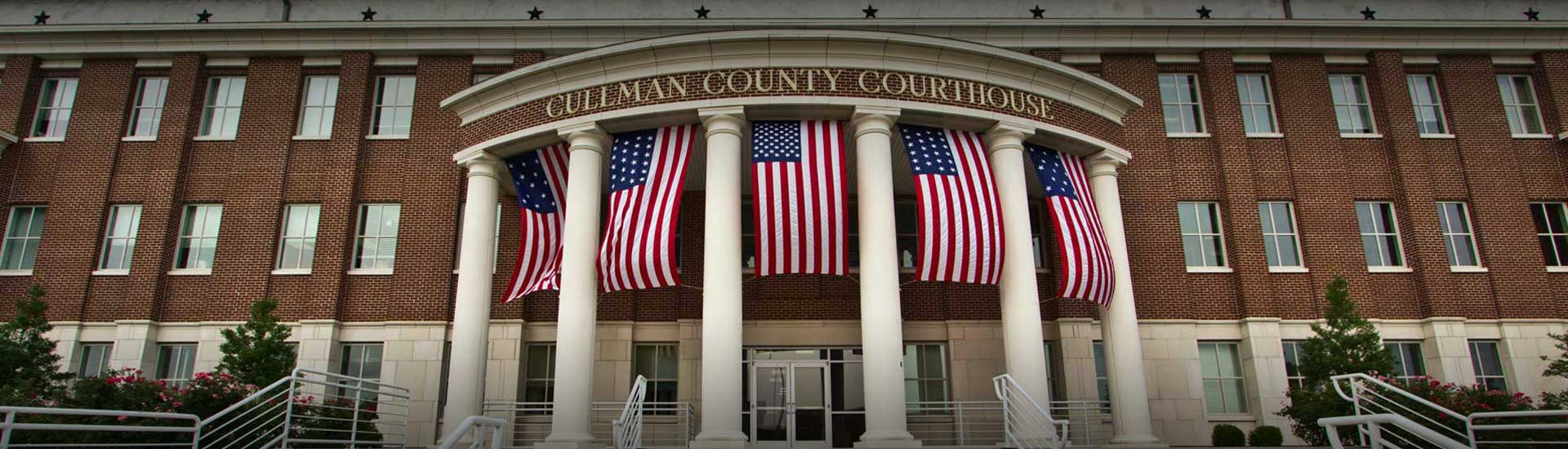 Cullman County Courthouse porch with Flags Displayed from highway 31 view